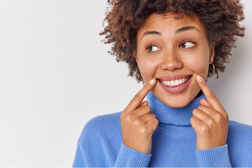 Blonde Woman With Freckles Smiles - Spicewood Dental Austin